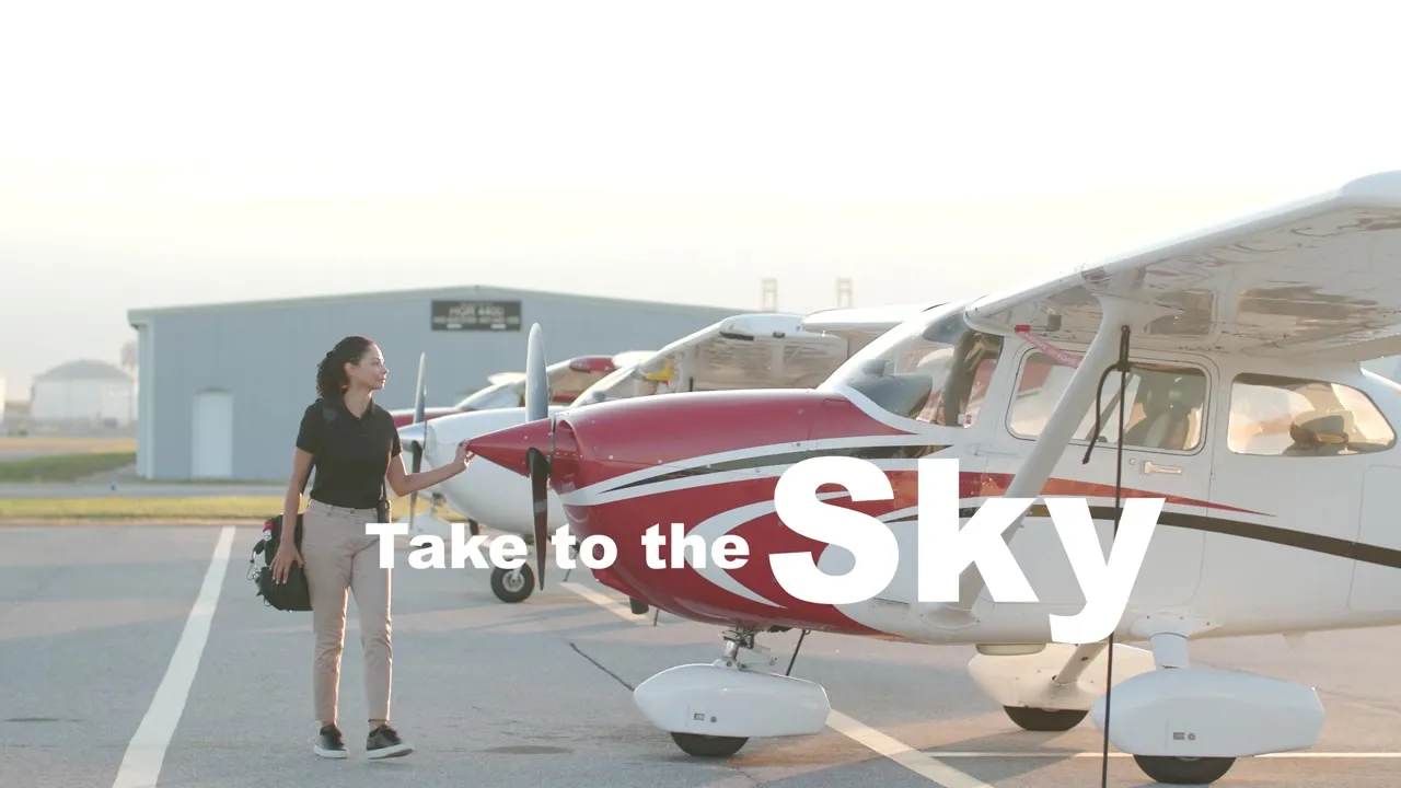 On-camera talent beside an aircraft at Peter O. Knight Airport during the Elevation brand film shoot